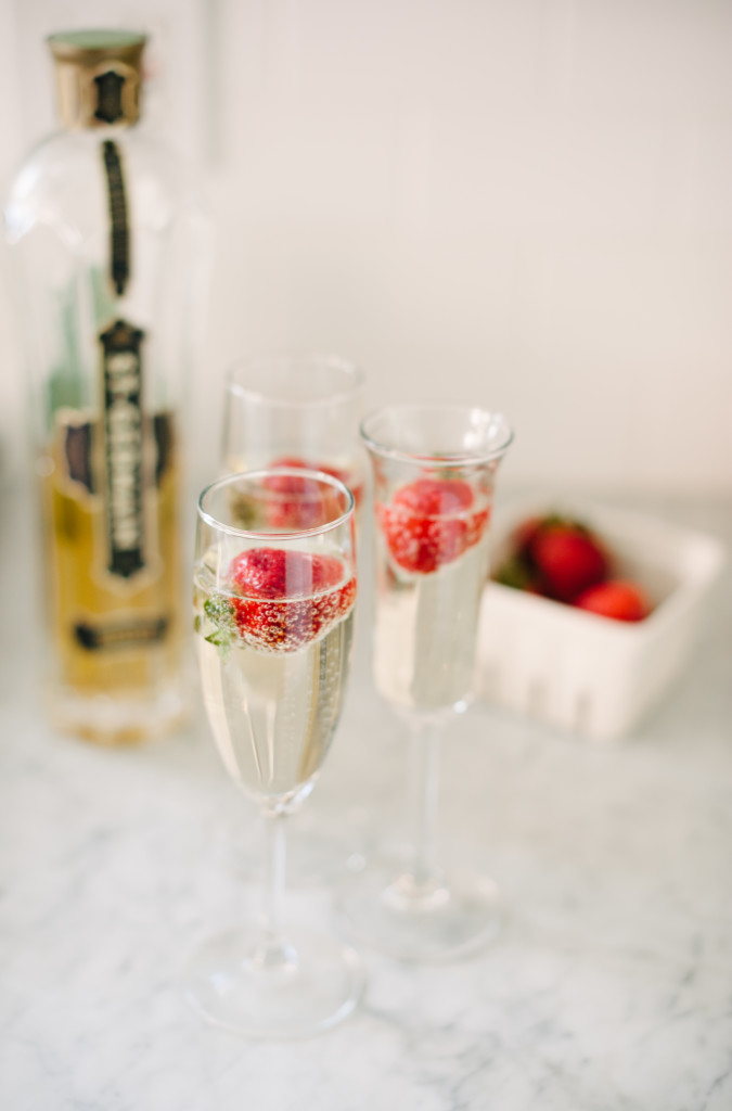 Prosecco + St Germaine Cocktails with strawberries or pomegranate seeds vis @simplyrealhealth and the Simply Real Health Cookbook! Perfect for the holidays!